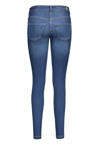 Tynne blå jeans laget av denim, med to baklommer, glidelås i front og en standard midjebånd med merkeetikett bak.