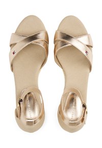 Gouden metalen sandalen met diagonale banden, een gestructureerde beige voetbed en een handige sluiting met een gesp, met het Tommy Hilfiger-logo aan de zijkant.