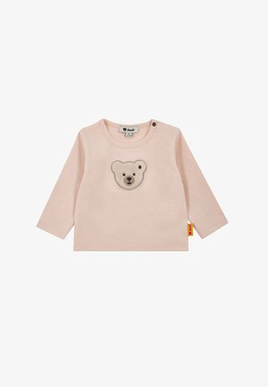 Light pink long-sleeve shirt featuring a bear face embroidered on the front. Soft cotton material with snap buttons at the shoulder.