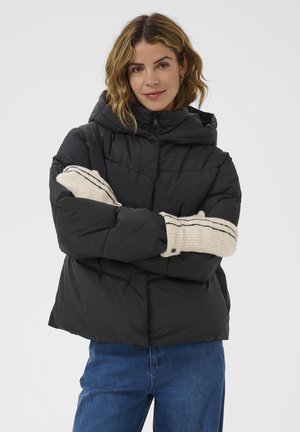 Black puffer jacket with a hood, featuring a quilted design and contrasting beige ribbed cuffs with black stripes. Casual fit.