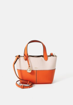 Small leather handbag with cream and orange sections. Features two handles, a detachable strap, and a metal charm. Textured finish.