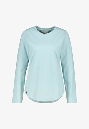 Chemise bleu clair à manches longues avec encolure ronde, ourlet incurvé et petite étiquette noire sur le côté inférieur, présentée sur fond blanc.
