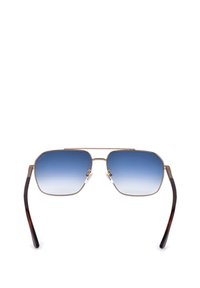 Lunettes de soleil à monture métallique avec verres carrés dégradés bleus et branches à embouts marron foncé sur fond blanc.