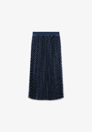 Jupe plissée bleu marine avec des pois blancs. Taille élastique pour le confort. Tissu léger avec une finition texturée.
