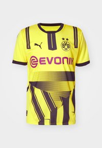 Maillot de football jaune et noir du Borussia Dortmund avec logo Puma, écusson BVB 09 avec deux étoiles, et nom du sponsor Evonik en violet sur le devant.