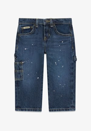 Short en denim bleu foncé longueur genou avec des éclaboussures de peinture et une petite poche latérale sur la jambe gauche.