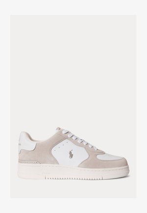 Low-top sneaker in beige suede and white leather with white laces, perforated details, and a small polo player logo on the side.