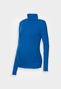 Sinine ribiga raseduse turtleneck, pikkade varrukatega. Omab kogutud detailingut külgedel ja lainelist serva varrukate otstes.