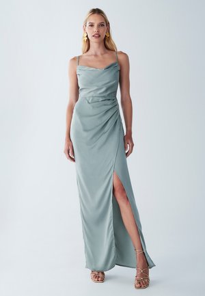 Long, fitted dress in soft green satin with a draped bodice, spaghetti straps, and a thigh-high slit, featuring sleek side detailing.