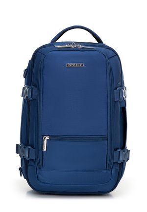 Blue fabric backpack featuring multiple straps, a front zip pocket, a top handle, and side pockets, designed for functionality and durability.