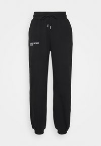 EMBROIDERED PANTS - Calças de fato de treino - black