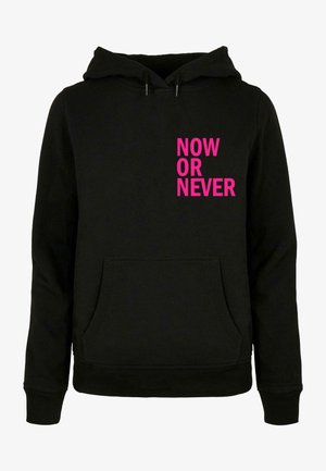 Schwarzer Kapuzenpullover mit einer Fronttasche, auf der linken Seite mit fettem pinken Text "JETZT ODER NIE". Aus Baumwollmischung.