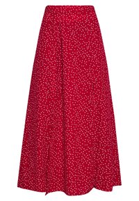 Jupe rouge à pois blancs, de forme évasée, longueur genoux, avec une ceinture. Fabriquée en un tissu lisse avec un léger tomber.