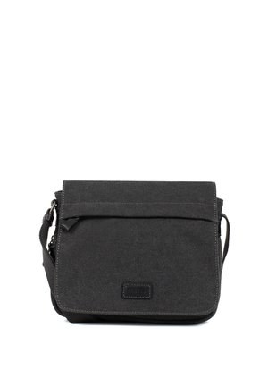 Petit sac d’épaule compact en tissu noir avec rabat pliable et bandoulière réglable, présenté sur fond blanc.