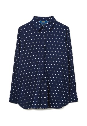 Navy blue long-sleeve button-up shirt with white polka dots and a pointed collar, laid flat against white background.