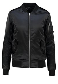 Veste bomber noire en tissu brillant, dotée d'une fermeture éclair sur le devant, de poches latérales et d'une poche zippée sur le bras gauche. Poignets et ourlet côtelés.