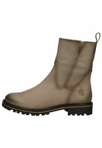 Botte cheville en cuir beige avec des panneaux latéraux élastiques, une languette et une semelle en caoutchouc noir robuste avec des motifs de traction.
