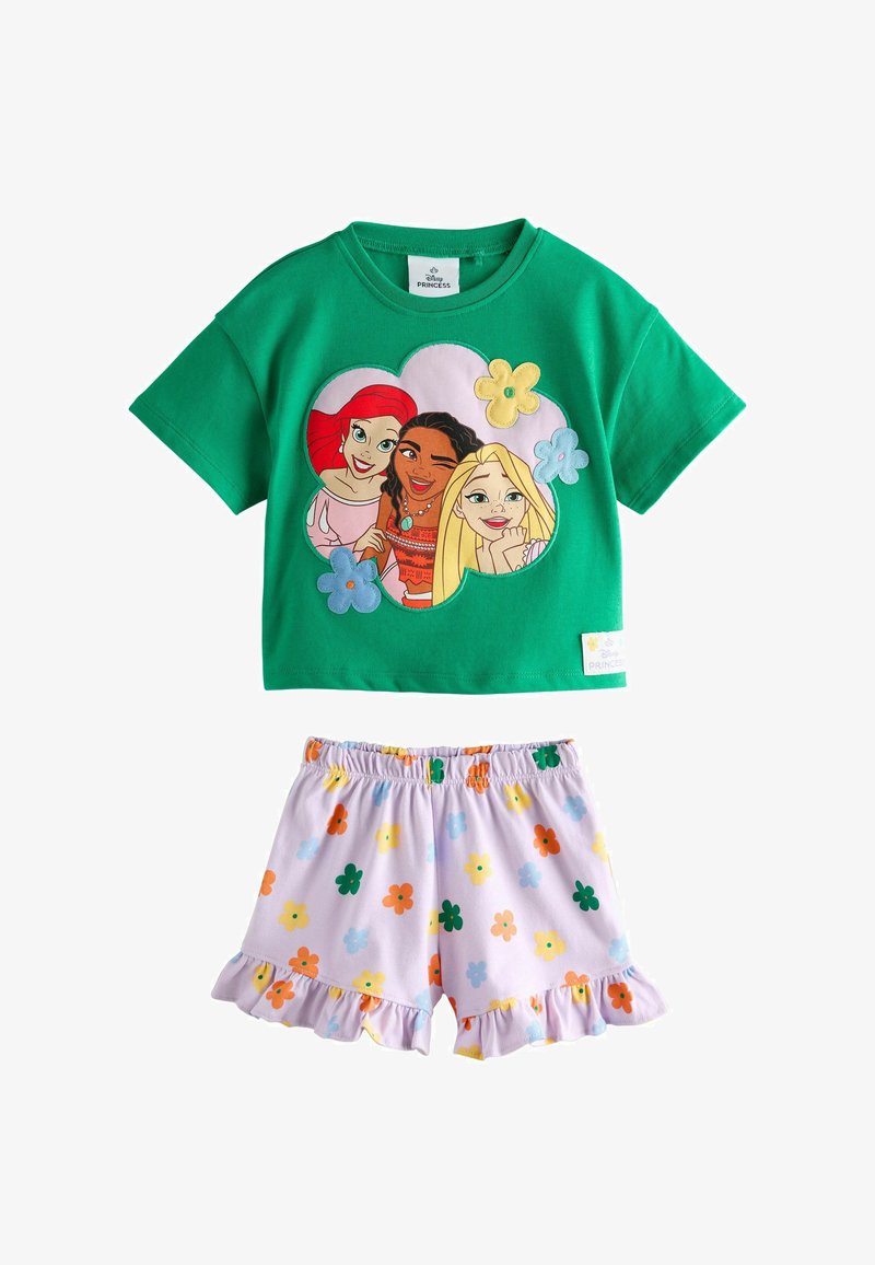 Haut vert à manches courtes avec imprimé des princesses Disney et short blanc avec motif floral coloré et ourlet à volants.
