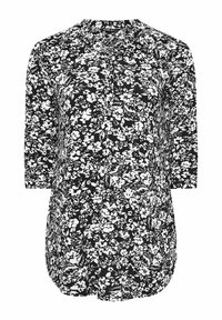 Blusa a stampa floreale in bianco e nero con chiusura a bottoni davanti, maniche a tre quarti e orlo arrotondato. Tessuto leggero con una consistenza morbida.