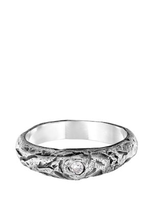 Silver ring with a textured, irregular surface and a prominent clear gemstone set in the center. Features a polished interior.