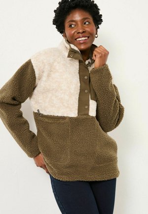 Fleece pullover featuring a brown and cream color block design, high collar, snap buttons, and a zippered front pocket. Soft texture.