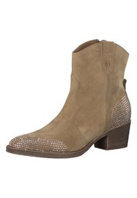 Bottine en suède marron avec un bout pointu, surface texturée et ornements de strass sur le bout et le côté. Talon en bois épais.
