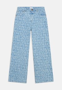 Light blue denim jeans with a repeating white text pattern. Features straight legs, standard five-pocket design, and brass button closure.