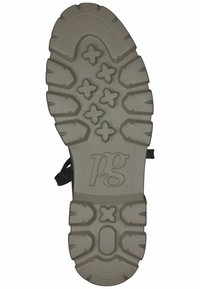 Semelle de chaussure avec une surface en caoutchouc texturé, présentant un mélange de motifs circulaires et en croix dans un gris clair, avec un logo de marque.