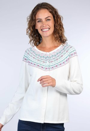 Weiße Langarm-Cardigan mit einem bunten gestickten Muster auf der Brust. Fünf Knöpfe zum Schließen und weiche Textur.