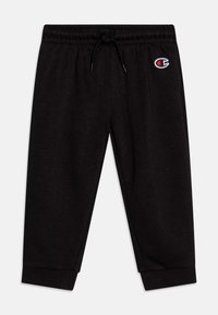 Pantalones de chándal negros con cintura elástica, cordón ajustable, puños acanalados y un pequeño logo bordado en el muslo. Textura de tela suave.