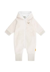 Beige Overall mit weißem Reißverschluss, Kapuze und einem Bären-Patch. Verfügt über eine Fronttasche und gerippte Bündchen. Weicher, fleece-artiger Stoff.