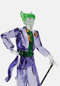 Crystal figure of a character with transparent green hair, purple jacket, green torso, orange accent, and holding a cane with gold hardware.
