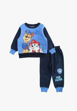 Ensemble pyjama deux pièces en bleu et marine, avec des personnages de dessin animé sur le haut. Matière en coton ; pantalon avec taille élastique et chevilles resserrées.