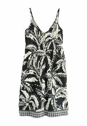 Schwarz-weißes ärmelloses Kleid mit einem Palmenblattmuster, das einen Knopfverschluss vorne, eine taillierte Taille und eine dekorative Bordüre entlang des Saums aufweist.
