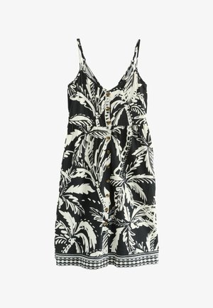 Schwarz-weißes ärmelloses Kleid mit einem Palmenblattmuster, das einen Knopfverschluss vorne, eine taillierte Taille und eine dekorative Bordüre entlang des Saums aufweist.