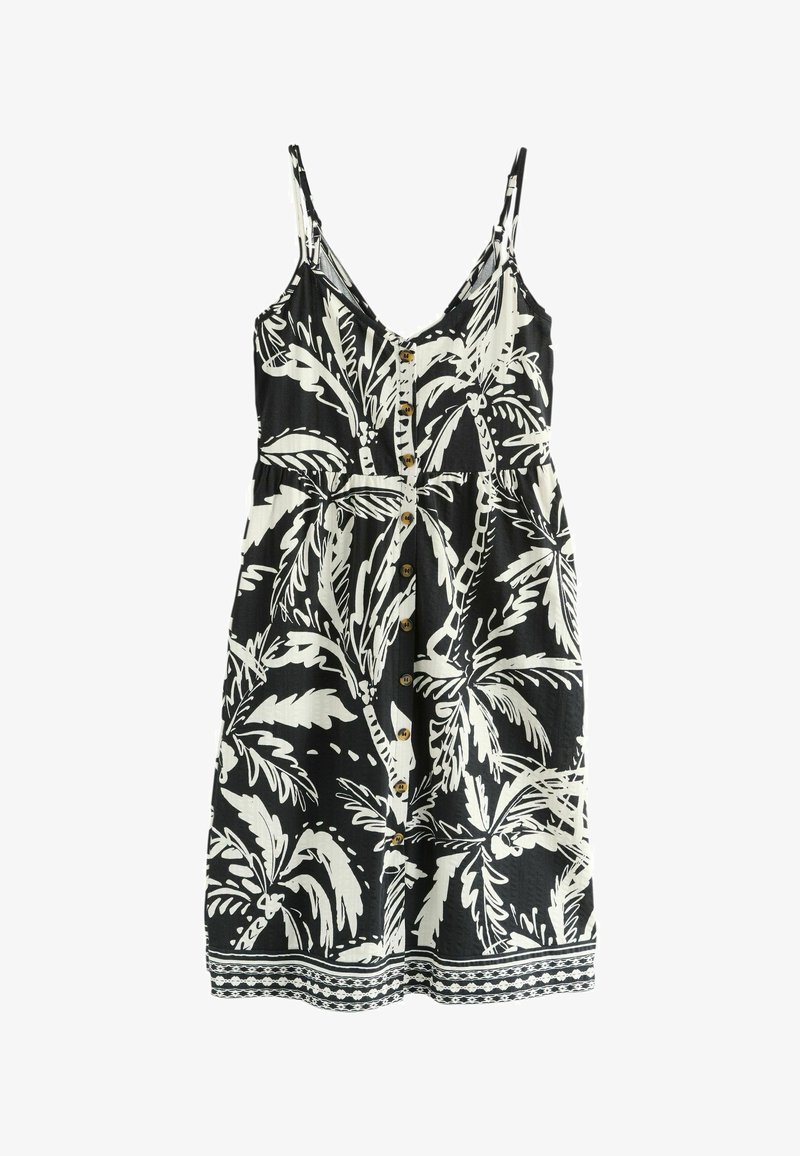 Schwarz-weißes ärmelloses Kleid mit einem Palmenblattmuster, das einen Knopfverschluss vorne, eine taillierte Taille und eine dekorative Bordüre entlang des Saums aufweist.