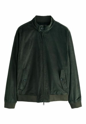 Dunkelgrüne Kordjacke mit Stehkragen, Frontreißverschluss und zwei geknöpften Taschen an den Seiten. Strukturierter Stoff sichtbar.