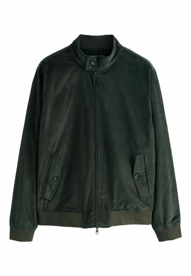 Donkergroene corduroyjas met een staande kraag, een ritssluiting aan de voorkant en twee knoopzakken aan de zijkanten. Textuur van de stof is zichtbaar.