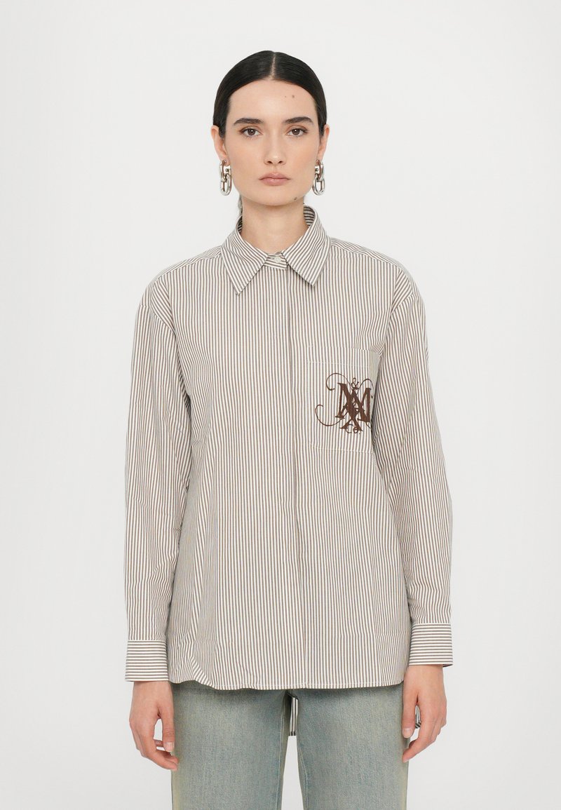 Striped, button-up shirt in light beige and brown, featuring a chest pocket with a brown logo. Long sleeves with buttoned cuffs.