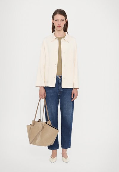 Light beige jacket, olive green top, blue relaxed jeans, beige tote bag, and off-white pointed shoes. Simple design, soft textures.