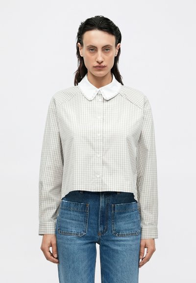 Cropped button-up shirt, light gray with a check pattern, white collar, long sleeves, and a smooth texture. Worn with high-waisted denim.