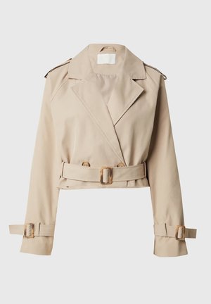 Beige cropped trench coat with wide lapels, double-breasted front, and belted waist. Designed with adjustable cuffs and minimal hardware details.