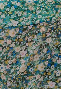 Floral fabric in shades of green, blue, and pink. Features small, scattered flowers on a textured background, creating a soft, blended look.