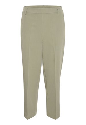 Pantalons effilés vert clair avec une texture lisse. Présentent un devant plat et une taille élastique pour le confort. Pas de poches ni de matériel visibles.