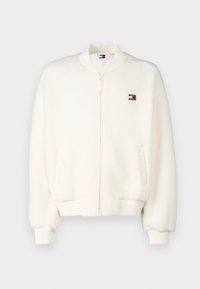 Crèmekleurige fleece bomberjack met voorrits, ribgebreide manchetten en zoom, zijzakken en een klein Tommy Jeans-logo op de borst.