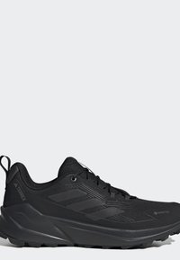 Czarny but do biegania trailowego Adidas Terrex z teksturowaną podeszwą, sznurowanym zapięciem i wodoodpornym materiałem Gore-Tex.