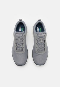 Gray mesh athletic shoes with a fabric upper, padded collar, lace-up front, and contrasting sole. Features 'Skechers Flex-Lite' branding.