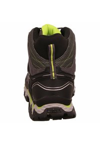 Black and gray hiking shoe with mesh upper, reflective accents, and a green collar. Features a textured sole for traction and stability.