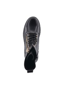 Botín negro de cuero con cremallera dorada, cordones y punta reforzada. Presenta un tirador en la parte trasera para facilitar su puesta. Tiene forma redondeada y textura suave.