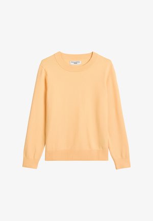 Jasnożółty, długi sweter z dzianiny z długim rękawem, zaokrąglonym dekoltem oraz ściągaczami na dole i przy mankietach. Tkanina wydaje się miękka i gładka.